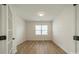 Bright bedroom boasts wood floors, neutral walls, a window, and doorway at 3918 Dahlia Dr # 15, Harrisburg, NC 28075