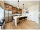 Bright kitchen features stainless steel appliances, a large island with bar seating, and hardwood floors at 3918 Dahlia Dr # 15, Harrisburg, NC 28075