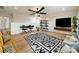 Open loft area features hardwood floors, a ceiling fan, stylish shelving, and natural light at 3918 Dahlia Dr # 15, Harrisburg, NC 28075