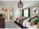 Stylish bedroom with neutral tones, accented with green decor, and plenty of natural light at 3918 Dahlia Dr # 15, Harrisburg, NC 28075
