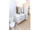 Double sink bathroom featuring floating vanity with modern sinks and black hardware, and tile flooring at 411 Cemetery St, Charlotte, NC 28216