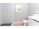 Modern bathroom featuring a stylish vanity, sleek fixtures, and a walk-in shower with contemporary tile, and natural light at 411 Cemetery St, Charlotte, NC 28216