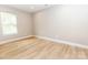 Bright, open bedroom with wood-look floors, a large window, and neutral tones, creating a peaceful and inviting space at 411 Cemetery St, Charlotte, NC 28216