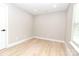 Neutral bedroom with wood-look flooring, great natural light, offering a blank canvas for personalized decor at 411 Cemetery St, Charlotte, NC 28216