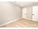 Bright, empty bedroom with white trim, baseboards and doors, and hardwood floors at 411 Cemetery St, Charlotte, NC 28216