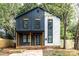 Stylish two-story home with unique architectural design, featuring a covered porch, wood accents, and ample natural light at 411 Cemetery St, Charlotte, NC 28216