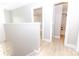 Bright hallway with white trim and doors leading to a bathroom with a tiled shower at 411 Cemetery St, Charlotte, NC 28216