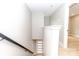 Hallway leading to stairs and a door with plank flooring and neutral color palette at 411 Cemetery St, Charlotte, NC 28216