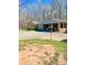 A single story house with a long driveway and covered parking surrounded by mature trees, and a quaint bird feeder at 453 Cotton Ct, York, SC 29745