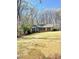 Traditional brick home with blue shutters, situated on a large, tree-lined lot, offering privacy and charm at 453 Cotton Ct, York, SC 29745