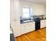 Bright kitchen featuring white cabinets and hardwood flooring at 453 Cotton Ct, York, SC 29745