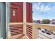Balcony overlooks parking lot with red brick building and blue sky in the background at 474 New Bern Station Ct, Charlotte, NC 28209