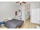 Bedroom featuring hardwood floors, ceiling fan, and a shelving unit at 474 New Bern Station Ct, Charlotte, NC 28209
