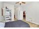 Bright bedroom features a ceiling fan, white shelving and access to the kitchen at 474 New Bern Station Ct, Charlotte, NC 28209