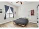 This bedroom features wood floors, a ceiling fan, and a window with natural light at 474 New Bern Station Ct, Charlotte, NC 28209