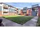 Exterior of a brick building with a view of the grassy courtyard at 474 New Bern Station Ct, Charlotte, NC 28209