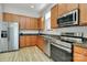 Kitchen with stainless steel appliances, light wood cabinets and granite countertops at 474 New Bern Station Ct, Charlotte, NC 28209