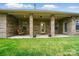 Back porch featuring brick columns, exterior door and a hanging swing at 5032 Eagles Crest Ln, Gastonia, NC 28056