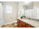 Bright bathroom featuring a granite countertop, wood cabinet, and tiled floors at 5032 Eagles Crest Ln, Gastonia, NC 28056