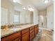 Bathroom featuring double sinks, granite counters, vanity, shower, and tile flooring at 5032 Eagles Crest Ln, Gastonia, NC 28056