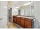 Bathroom featuring double sinks, granite counters, vanity, and tile flooring at 5032 Eagles Crest Ln, Gastonia, NC 28056
