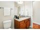 Well-lit bathroom featuring granite countertop, wood cabinet, tiled floors, and a toilet at 5032 Eagles Crest Ln, Gastonia, NC 28056