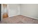 Bedroom with carpet floors and a door to the hallway at 5032 Eagles Crest Ln, Gastonia, NC 28056