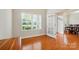 Sunlit room with hardwood floors and glass door access to dining area at 5032 Eagles Crest Ln, Gastonia, NC 28056