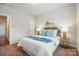 Cozy bedroom showcasing a well-decorated bed, side tables with lamps, and carpeted floors at 5032 Eagles Crest Ln, Gastonia, NC 28056