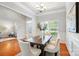 Dining area boasts hardwood floors, modern chandelier, and window views, creating a welcoming atmosphere at 5032 Eagles Crest Ln, Gastonia, NC 28056