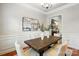 Dining room features a rustic wood table with seating and views into the kitchen of the home at 5032 Eagles Crest Ln, Gastonia, NC 28056