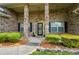 Charming brick home with a welcoming front porch, lush landscaping, and inviting curb appeal at 5032 Eagles Crest Ln, Gastonia, NC 28056