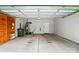 Spacious garage with shelving, a water heater, lawn mower, and an overhead door at 5032 Eagles Crest Ln, Gastonia, NC 28056