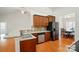 Well-lit kitchen with stainless steel appliances, granite countertops and wooden cabinets at 5032 Eagles Crest Ln, Gastonia, NC 28056