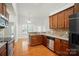 The spacious kitchen has wood cabinets, stainless appliances and granite counters at 5032 Eagles Crest Ln, Gastonia, NC 28056