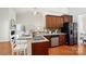 Open kitchen featuring granite countertops, wood cabinets, stainless steel appliances, and hardwood floors at 5032 Eagles Crest Ln, Gastonia, NC 28056