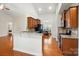 Kitchen featuring granite countertops, wood cabinets, stainless steel appliances, and hardwood floors at 5032 Eagles Crest Ln, Gastonia, NC 28056