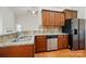 Kitchen with stainless appliances, granite countertops, hardwood floors, and tile backsplash at 5032 Eagles Crest Ln, Gastonia, NC 28056