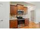 Kitchen features stainless appliances, granite counters, wood cabinets and a microwave at 5032 Eagles Crest Ln, Gastonia, NC 28056