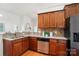 Kitchen featuring granite countertops, wood cabinets, stainless steel appliances, and hardwood floors at 5032 Eagles Crest Ln, Gastonia, NC 28056