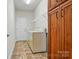 Laundry room features tile flooring, washer, dryer and cabinet storage at 5032 Eagles Crest Ln, Gastonia, NC 28056
