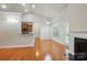 Open concept living room and kitchen features a fireplace and breakfast bar at 5032 Eagles Crest Ln, Gastonia, NC 28056