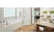 This primary bathroom features a soaking tub, double sink vanity, and nice flooring at 5032 Eagles Crest Ln, Gastonia, NC 28056