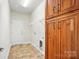 Mud room features wood cabinets, door to the exterior, flooring, and lots of storage at 5032 Eagles Crest Ln, Gastonia, NC 28056