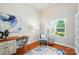 Cozy home office with natural light, hardwood floors, and comfortable seating for a productive workspace at 5032 Eagles Crest Ln, Gastonia, NC 28056