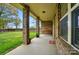 Covered front porch area with brick columns and a porch swing at 5032 Eagles Crest Ln, Gastonia, NC 28056