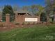 Eagles Walk neighborhood sign is brick with iron fencing and landscaping in front at 5032 Eagles Crest Ln, Gastonia, NC 28056