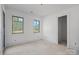 Bright bedroom with two windows and neutral walls at 5039 Eliza Long Wilkie Dr, Huntersville, NC 28078