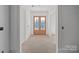 Unfinished entryway featuring a beautiful, light-stained wood front door with glass panes and a bright, open space at 5039 Eliza Long Wilkie Dr, Huntersville, NC 28078
