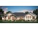 Charming exterior elevation with stone accents, vertical siding, dark metal roof, and mature landscaping at 5039 Eliza Long Wilkie Dr, Huntersville, NC 28078